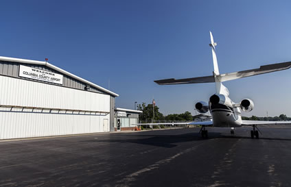 photo of Richmor aviation private charter jet next to hanger